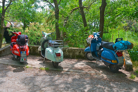 Villaggio di Punta Sdobba, Italy - June 14 2020. Three Vespas, part of a small rally of Vespa motorikes parked in the wetland area of Isola Della Cona in Friuli-Venezia Giulia, north east Italyのeditorial素材