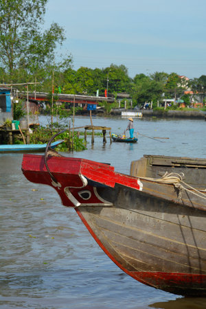 Phong Dien, Vietnam - December 31st 2017. The painted bow of a boat on the river at the Phong Dien Floating Market near Can Tho in the Mekong Deltaのeditorial素材