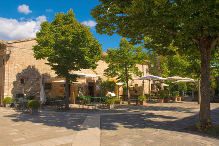 Bagno Vignoni, Italy - September 3rd 2020. Shady bars in the historic village of Bagno Vignoni in Val d'Orcia, Siena Province, Tuscany, famous for it's hot springsのeditorial素材