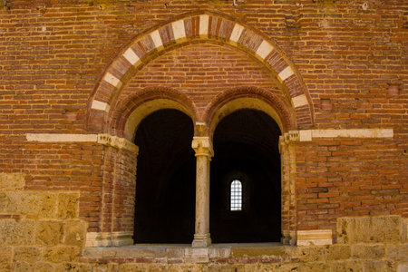 Chiusdino, Italy - 7th September 2020. A double arched or radius window in the remains of the roofless San Galgano Abbey in Siena Province, Tuscany. The  Gothic 13th-century Abbey was founded as a Cistercian Monasteryのeditorial素材