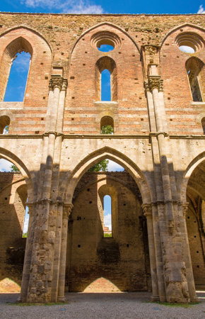 Chiusdino, Italy - 7th September 2020. The roofless San Galgano Abbey in Siena Province, Tuscany. Arch or radius windows at the top, and an arcade of lancet or pointed arches at the bottom. The Gothic 13th-century Abbey was founded as a Cistercian Monasteのeditorial素材