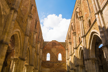 Chiusdino, Italy - 7th September 2020. The roofless San Galgano Abbey in Siena Province, Tuscany. Arch or radius windows at the top, and an arcade of lancet or pointed arches at the bottom. The Gothic 13th-century Abbey was founded as a Cistercian Monasteのeditorial素材