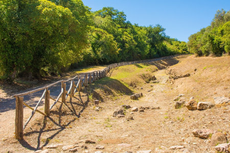 Grosseto, Italy - September 4th 2020. The ruins of  the Paved Etruscan Road in Roselle or Rusellae, an ancient Etruscan and Roman city in Tuscany. The road leads toward the centre of Roselleのeditorial素材