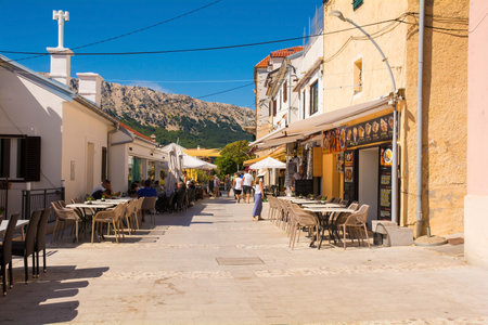 Baska, Croatia - 4th September 2021. A street in late summer in historic coastal town of Baska on Krk island in the Primorje-Gorski Kotar County of western Croatiaのeditorial素材