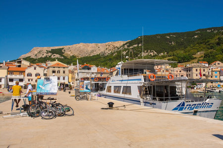 Baska, Croatia - 4th September 2021. Boat trip sellers wait for customers on a pier in the south Krk island town of Baska in the Primorje-Gorski Kotar County of western Croatiaのeditorial素材