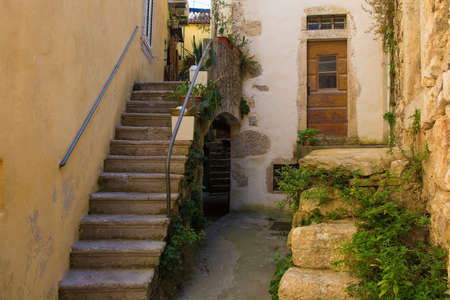 Steps in quiet residential street in the historic medieval centre of Vrbnsk hill village on Krk Island in the Primorje-Gorski Kotar County of western Croatiaの写真素材