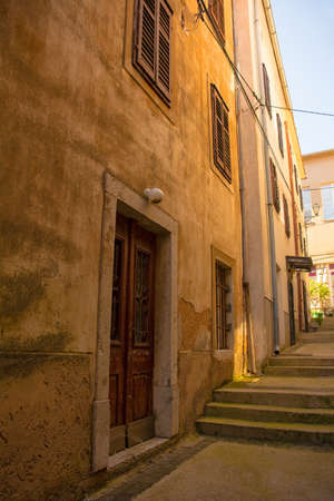 A quiet residential street in the historic hill village of Dobrinj on Krk island in the Primorje-Gorski Kotar County of western Croatiaの写真素材