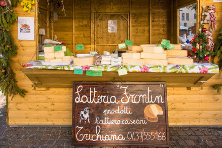 Belluno, Italy - December 11th 2021. A cheese stall at a traditional Christmas market in Piazza dei Martiri in the historic centreのeditorial素材