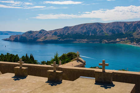 Graves in the grounds of St John the Baptist Church on a hill above Baska, Krk island,...