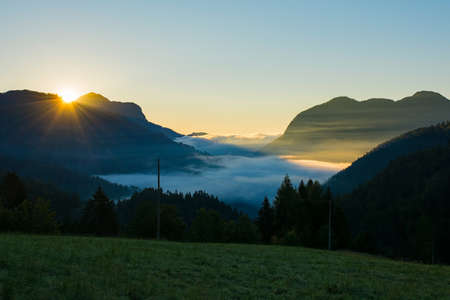 Low clouds as dawn breaks over Sauris Valley near the Alpine village of Sauris di Sopra, Udine...