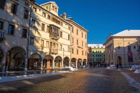 Belluno, Italy - December 11th 2021. December snow in an historic street in the north east Italian...