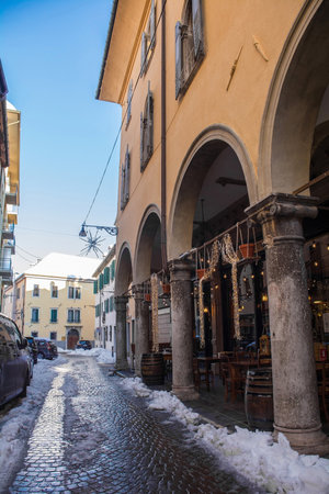 Belluno, Italy - December 11th 2021. December snow in an historic street in the north east Italian city of Belluno, Veneto regionのeditorial素材
