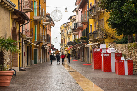 Lazise, Italy - December 27th 2021. An historic street in Lazise on the shore of lake Garda at Christmas. In Verona Province, Veneto, north east Italyのeditorial素材