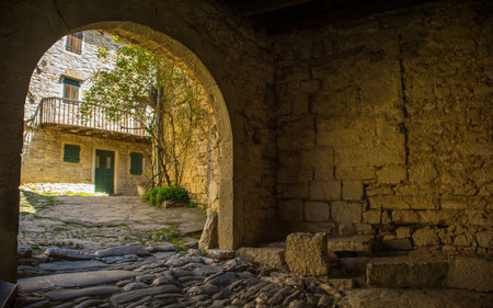 The passage through the entrance gate to the medieval village of Hum in Istria, Croatia, often...