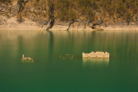 The remains of Movada village in Lago dei Tramonti in val Tramontina valley, Pordenone province, Friuli-Venezia Giulia, north east Italy. The village was flooded when a dam was built in 1952 and is seen during low waterの写真素材
