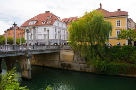 Ljubljana, Slovenia - September 3rd 2022. The historic Cobblers Bridge crossing the Ljubljanici River in central Ljubljana, Slovenia. The bridge is known as Sustarski Most in Slovenianのeditorial素材