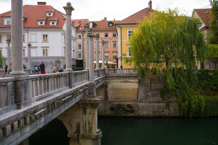 Ljubljana, Slovenia - September 3rd 2022. The historic Cobblers Bridge crossing the Ljubljanici River in central Ljubljana, Slovenia. The bridge is known as Sustarski Most in Slovenianのeditorial素材