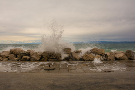Rough waves and high water on the waterfront of Piran town in Slovenia in mid Septemberの写真素材