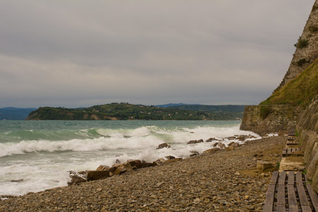 Rough waves and stormy weather at one of Piran's city beaches, Slovenia, mid Septemberの写真素材