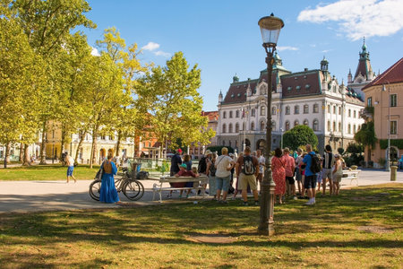 Ljubljana, Slovenia - September 4th 2022. A tour group stops to listen to their guide on a summer afternoon in Park Zvezda in the centre of Ljubljana, Sloveniaのeditorial素材