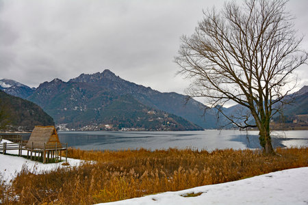 A recreation of a traditional straw hut on the south east shore of Lago di Ledro near Riva del Garda on Lake Garda, Trentino-Alto Adige, north east Italyの写真素材
