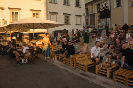 Ljubljana, Slovenia - September 3rd 2022. Tourists and locals enjoy food and drink at an outdoor street food market in Pogacarjev Trg in central Ljubljana, Sloveniaのeditorial素材