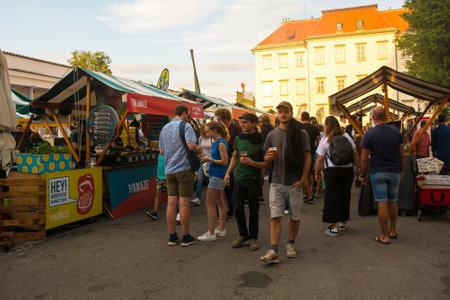 Ljubljana, Slovenia - September 3rd 2022. Tourists and locals enjoy food and drink at an outdoor street food market in Pogacarjev Trg in central Ljubljana, Sloveniaのeditorial素材
