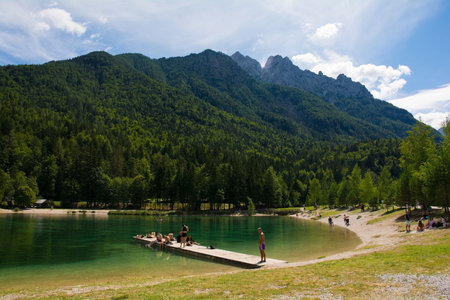 Kranjska Gora, Slovenia - August 21st 2022. Tourists spending time at Jasna Lake near Kranjska Gora in the Upper Carniola region of north west Slovenia. An artificial lake created for tourism purposesのeditorial素材