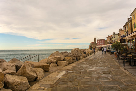 Piran, Slovenia - September 17th 2022. The waterfront of the historic medieval town of Piran on the coast of Slovenia. Centre background is Our Lady of Health and a 17th century lighthouse towerのeditorial素材