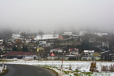 The foggy snowy winter landscape on the outskirts of Villach in Carinthia, Austriaの写真素材