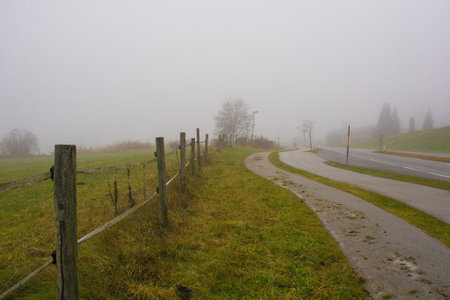 The foggy winter landscape near Ossiacher See Lake in Carinthia, Austria. Located in the southern Nock Mountain range of the Gurktal Alps near Villachの写真素材