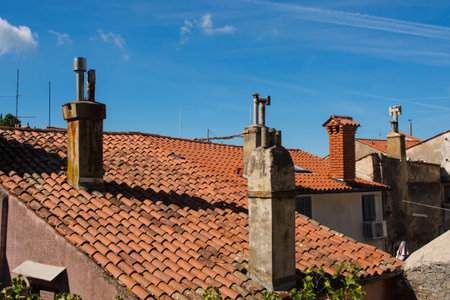 Traditional terracotta tiled roofs on historic buildings in the medieval centre of Piran on the coast of Sloveniaの写真素材