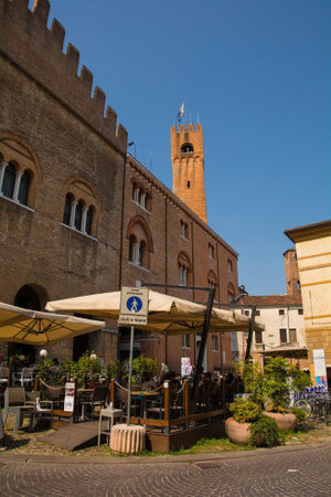 Treviso, Italy - 24th July 2022. A cafe bar in Via San Michele in the historic centre of Treviso in Veneto, north east Italy. Torre Civico, the civil tower, can be seen in the backgroundのeditorial素材