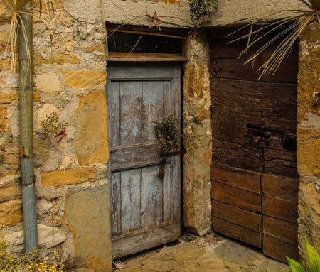 Old wooden doors in Poffabro, an historic medieval village in the Val Colvera valley in Pordenone province, Friuli-Venezia Giulia, north east Italyの写真素材