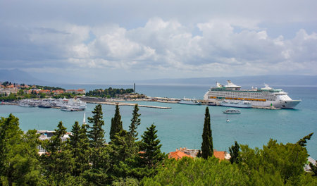 A view of the historic coastal town of Split in Croatia from Marjan Hill which overlooks the town, Cruise ships and ferry boats can be seen in the harbour areaの写真素材