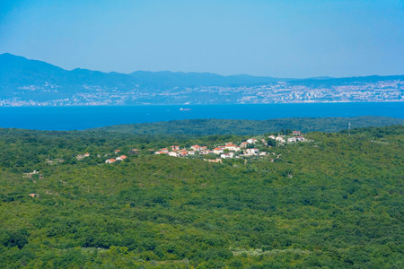 The landscape around the historic medieval hill village of Dobrinj on Krk island in the Primorje-Gorski Kotar County of western Croatia. Suzan village is in the centre, while Rijeka on the Croatian mainland can be seen in the backgroundの写真素材
