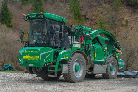 Forni Avoltri, Italy - April 8th 2023. An industrial wood chipper off road capability at a forested logging site near the mountain village of Forni Avoltri in Carnia, Udine Province, Friuli-Venezia Giulia, north east Italyのeditorial素材