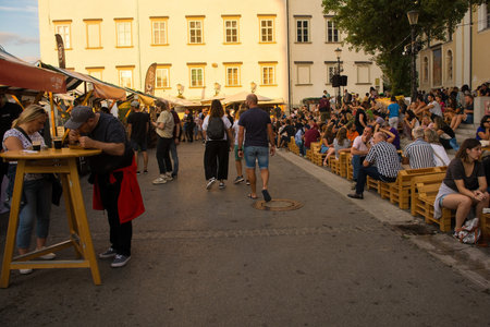 Ljubljana, Slovenia - September 3rd 2022. Tourists and locals enjoy food and drink at an outdoor street food market in Pogacarjev Trg in central Ljubljana, Sloveniaのeditorial素材