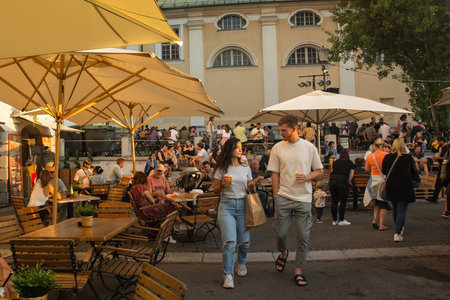 Ljubljana, Slovenia - September 3rd 2022. Tourists and locals enjoy food and drink at an outdoor street food market in Pogacarjev Trg in central Ljubljana, Sloveniaのeditorial素材