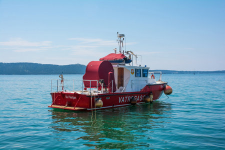 Kastela, Croatia - May 21st 2023. A fireboat, or fire-flat, off the coast of Kastel Gomilica in Kastela, central Croatiaのeditorial素材