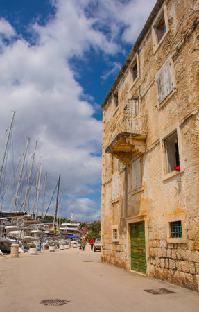Milna, Croatia - May 16th 2023. An historic stone house on the waterfront of Milna Village on the west coast of Brac Island in Croatiaのeditorial素材
