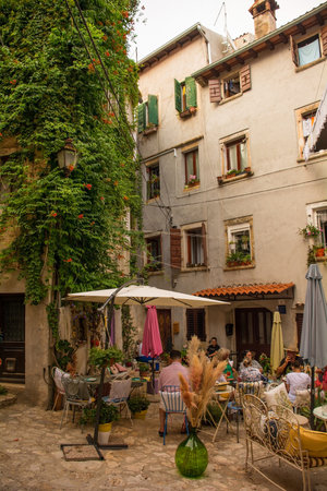 Rovinj, Croatia - July 10th 2023. A small bar in a quiet back street of the historic centre of Rovinj old town in Istria, Croatiaのeditorial素材