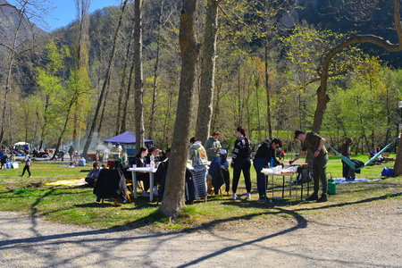 Lago Cavazzo, Italy - April 10th 2023. Groups of young people and families celebrate Easter Monday in the park on the shore of Lago Cavazzo lake with picnics and barbecuesのeditorial素材