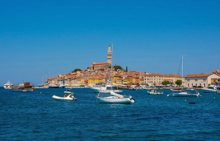 Boats on the historic waterfront of the medieval coastal town of Rovinj in Istria, Croatia. Saint Euphemia Church is centralの写真素材