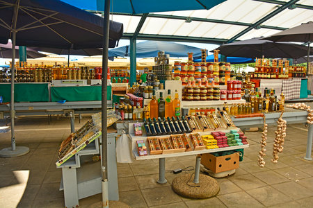 Rovinj, Croatia - July 9th 2023. A small outdoor market in Rovinj old town in Istria, Croatia. It sells fruit, vegetables and souvenirs such as honey, oils and spiritsのeditorial素材