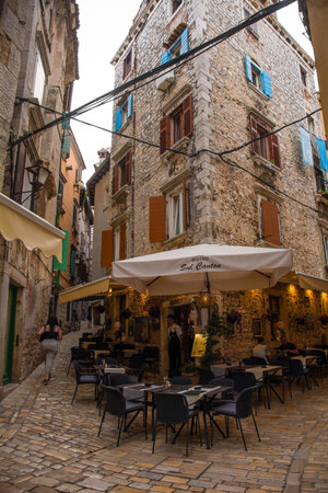 Rovinj, Croatia - July 10th 2023. A small bar in a quiet back street of the historic centre of Rovinj old town in Istria, Croatiaのeditorial素材