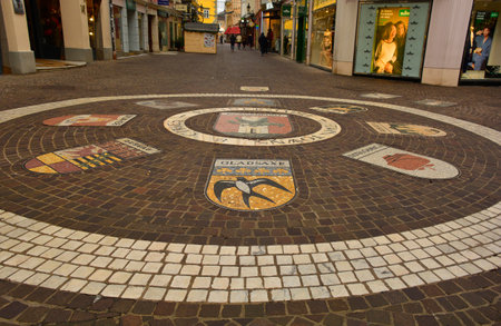 Klagenfurt am Worthersee, Austria - December 25th 2022. The coats of arms of twinned cities on the pavement in Kramergasse street in the historic centre of Klagenfurt, Carinthia, Austriaのeditorial素材