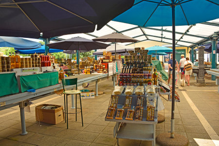 Rovinj, Croatia - July 9th 2023. A small outdoor market in Rovinj old town in Istria, Croatia. It sells fruit, vegetables and souvenirs such as honey, oils and spiritsのeditorial素材