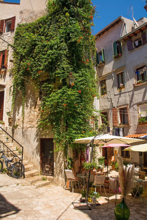 Rovinj, Croatia - July 7th 2023. A small bar in a quiet back street of the historic centre of Rovinj old town in Istria, Croatiaのeditorial素材