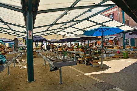 Rovinj, Croatia - July 9th 2023. A small outdoor market in Rovinj old town in Istria, Croatia. It sells fruit, vegetables and souvenirs such as honey, oils and spiritsのeditorial素材